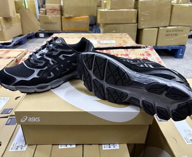 ASICS black-and-grey mesh running sneakers shown with outsole
