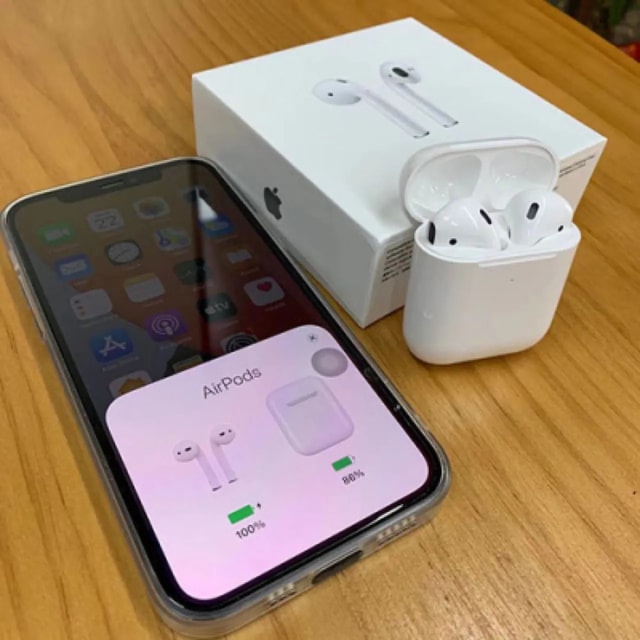 AirPods 2 connected to a phone beside its retail box