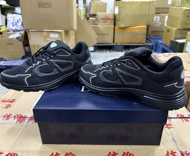 Black reflective mesh runner sneakers shown from the side