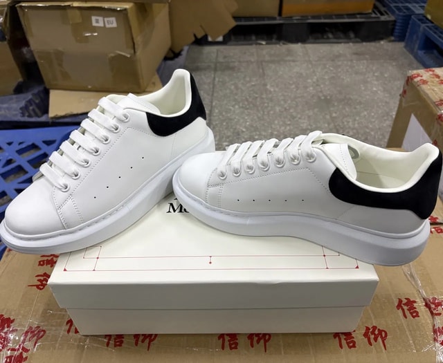 White platform low-top sneakers with black heel tabs